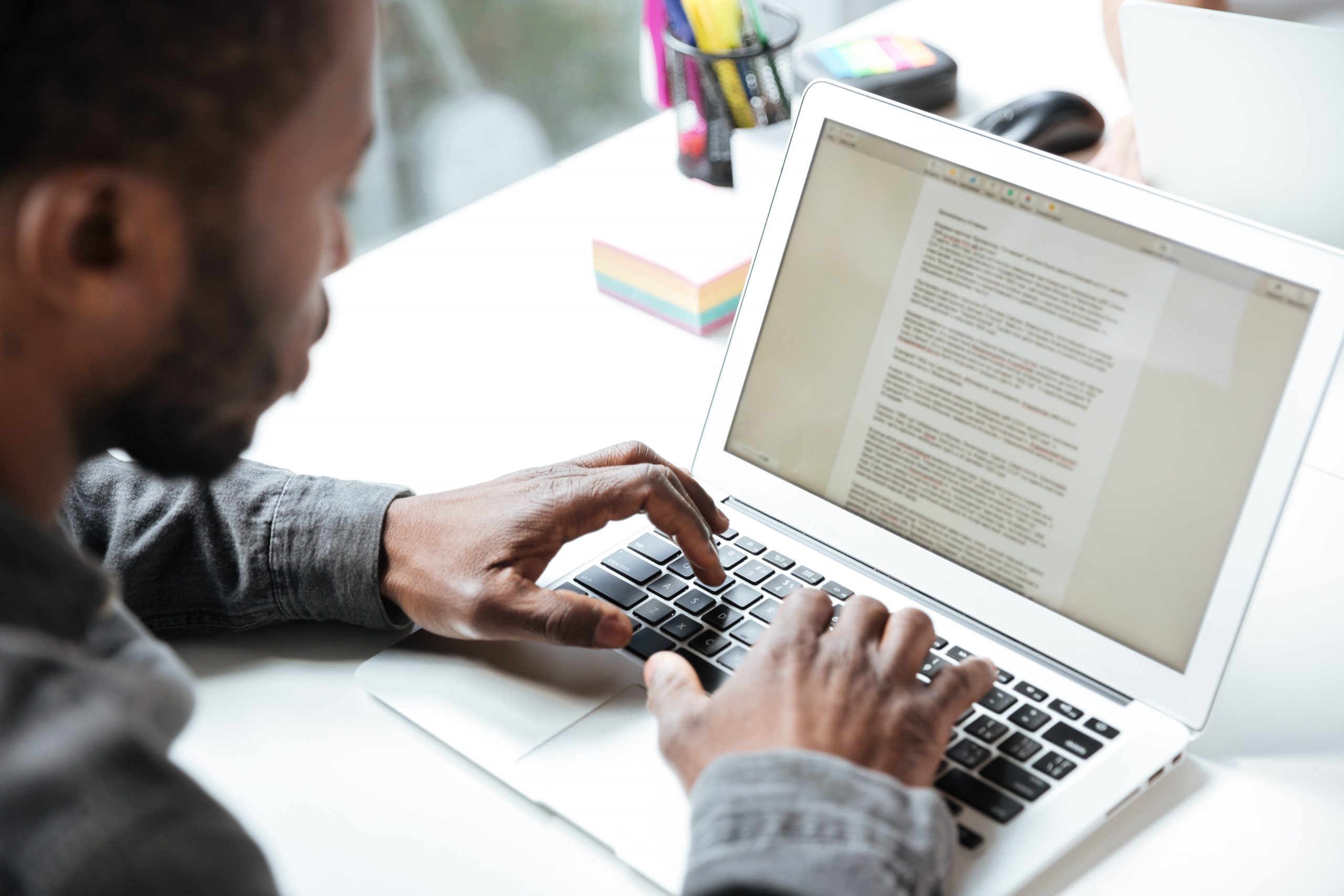 Man writing on a computer